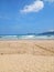 Iconic Banyuwangi (indonesia) Beach called Pantai Pulau Merah with blue sky and a uninhabited island. taken at May, 2023