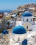 Iconic blue domes and hillside coastline at Oia Santorini