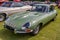 An iconic British classic Jaguar E-Type sports car at a public car show
