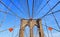 Iconic brooklyn bridge construction, arch and modern patterns against blue sky in Manhattan, Ney York