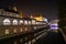 Iconic building of the central market in Ljubljana illuminated at night, the bridge of Preseren sqare in the background