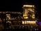 The iconic Chain Bridge at night in Budapest Hungary that carries traffic across the River Danube in the Baroque city of Budapest