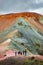 Iconic colorful rainbow volcanic mount Brennisteinsalda in Landmannalaugar mountains and group of hikers in Iceland, summer