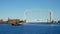 Iconic Duluth Minnesota aerial lift bridge with yellow tug boat in the harbor