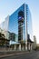 The iconic Entel tower reflected on a modern office building