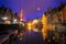 Iconic fairytale view of the canals of Bruges  during the rain. Nepomucenus Bridge and Church of Our Lady Bruges in the background