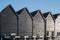 Iconic fishermen huts in black wood in Whitstable harbour, Kent, Uk