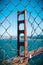 Iconic Golden Gate Bridge through a fence, San Francisco