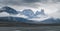 Iconic granite rock of Mt.Asgard towers above Turner glacier on a very cloudy and foggy day in remote arctic valley of