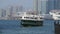 Iconic green Star ferry approaching terminal on Kowloon side of Victoria harbour