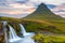 Iconic icelandic tourist attraction, waterfall by a very tall, pointed mountain, Iceland Kirkjufell and Kirjufellsfoss