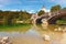 Iconic landmark in Bohinj Lake Bohinjsko jezero. Ancient John the Baptist Church with medieval stone bridge