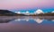 Iconic Oxbow Bend on an Autumn Morning with Purple Skies and Snow capped Mountains