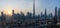 Iconic panorama at sunset of Burj Khalifa and Dubai Skyline as sun sets with and other skyscrapers in the Middle East with blue