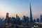 Iconic panorama at sunset of Burj Khalifa and Dubai Skyline as sun sets with and other skyscrapers in the Middle East with blue