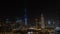 Iconic panorama at sunset of Burj Khalifa lit up with Emaar and Dubai Skyline as sun sets with blue and purple colors and other