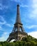 Iconic Paris Eiffel Tower against a bright blue sky