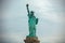 Iconic Statue of Liberty standing against a cloudy sky