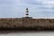 Iconic striped Seaham lighthouse in the middle of a sea wall
