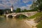 Iconic view of Lake Bohinj with the stone bridge over the water with Saint John the Baptist Church in the background