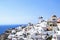 Iconic view of the whitewashed houses in Santorini, overlooking the ocean.