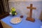 Iconic wooden cross with candles & flowers