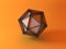 Icosahedron crystal over yellow background. 3d