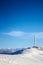 Icy cellular base station antenna covered with snow. Cell site tower on moutain hill. Telephone network transceivers and