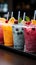 Icy fruit slushies stand united in plastic cups, forming a chilly lineup