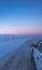 Icy landscape from a 4x4 car on a totally snowy road with tire tracks reaching to the horizon with a magical purple Icelandic