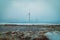 icy puddle on snowy fields with windmills in the background