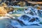 Icy river over frosty rocks in California park