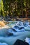 Icy river in wilderness cascading over icy and frosty rocks