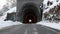 Icy road with ancient stone tunnel in winter scenic
