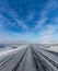 Icy road in Iceland with blue sky