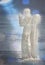 Icy sculpture of frozen angel in winter lake. Winter card