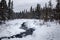 An icy stream flows down a creek after heavy snowfall