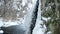 Icy Water Flow Serene video capturing a winter waterfall with snow-covered rocks