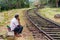IDALGASHINNA, SRI LANKA - JULY 16, 2015: Worker maintaing a railway track between Idalgashinna and Haputale makes a cal