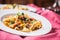 Idalian pasta pappardelle with beef ragout on white plate