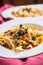 Idalian pasta pappardelle with beef ragout on white plate