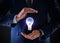 Idea concept. Businessman demonstrating glowing light bulb illustration on background, closeup