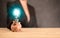Idea concept. businesswoman holds a glowing blue light bulb. Woman hand holding light bulb on wooden desk. Concept new idea with