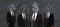 Idea and financial development concept. Headless businessmen in suits standing on chalkboard background
