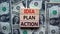 Idea, plan, action symbol. Wooden blocks form the words `Idea, plan, action` on beautiful background from dollar bills. Business