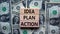 Idea, plan, action symbol. Wooden blocks form the words `Idea, plan, action` on beautiful background from dollar bills. Business