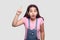 Idea. Portrait of surprised brunette young girl in casual pink t-shirt and blue denim overalls standing with idea gesture and