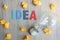 Idea TEXT on and crumbled paper with lightbulb on wooden table background. vision, Creative, Innovation, Imagination, inspiration