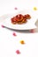 Idea for Valentine treats pretzel dip chocolate in ceramic heart shape plate on white background with copy space
