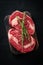 Ideal raw rib eye beef steak with rosemary on black wooden background